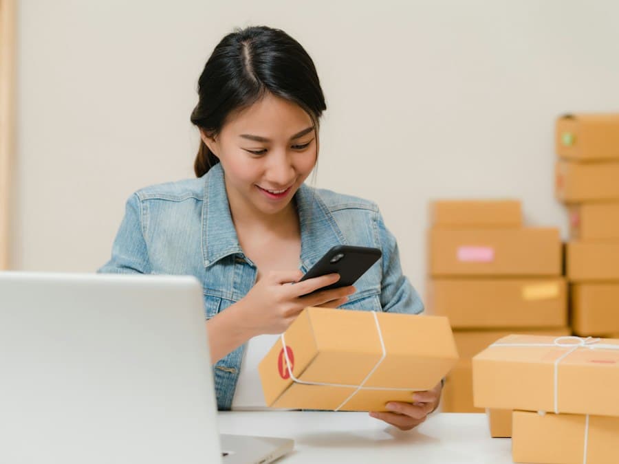 A small-business owner checking an order on her phone beside parcels