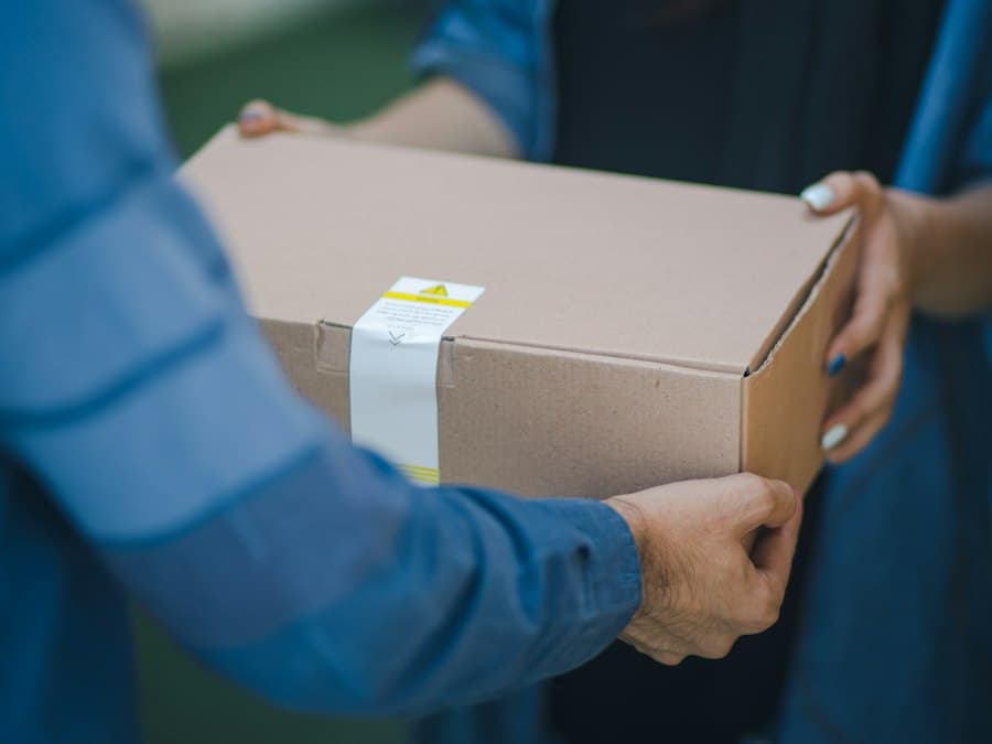 A courier handing a parcel to a customer